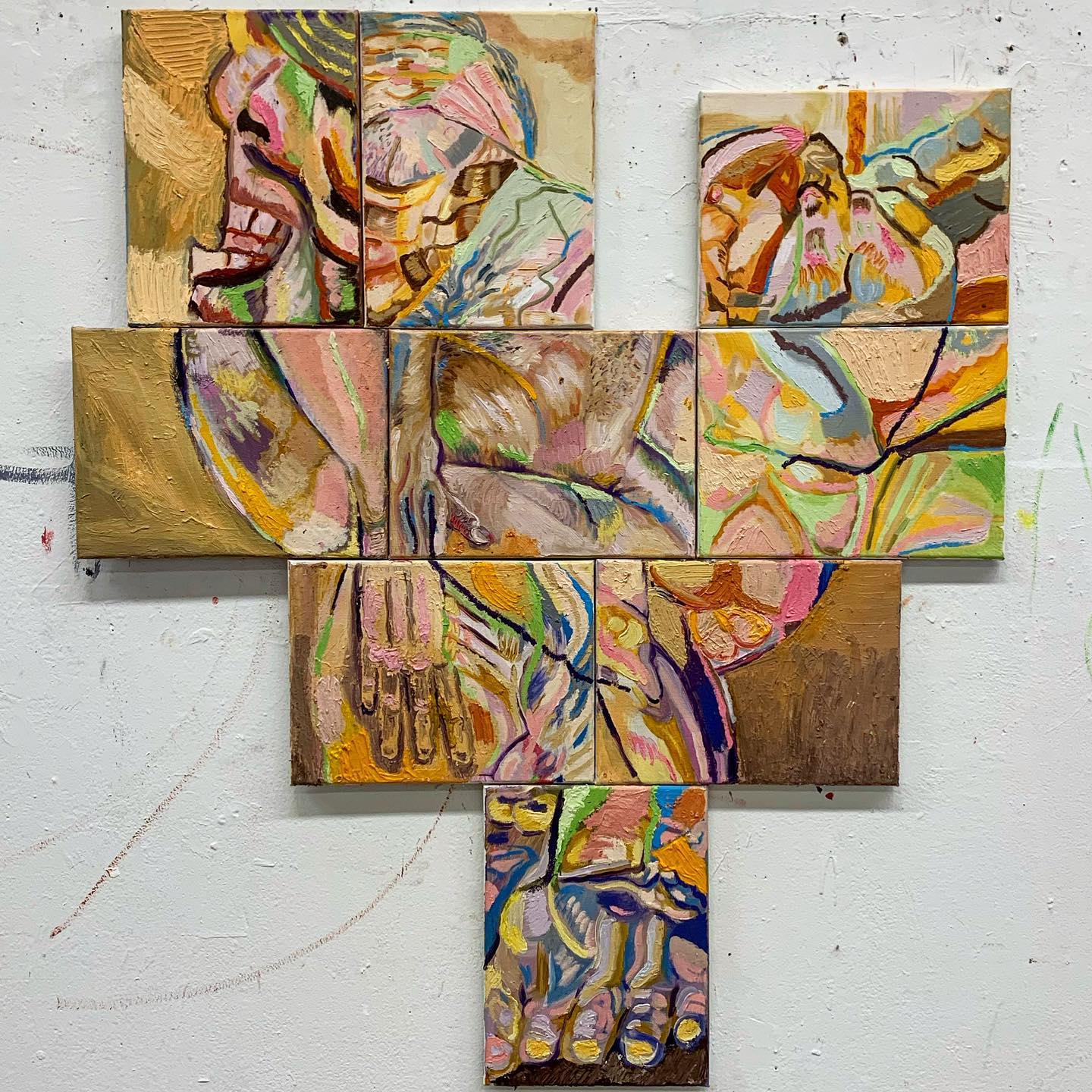 An assembled group of canvases with an abstract figure painted onto it